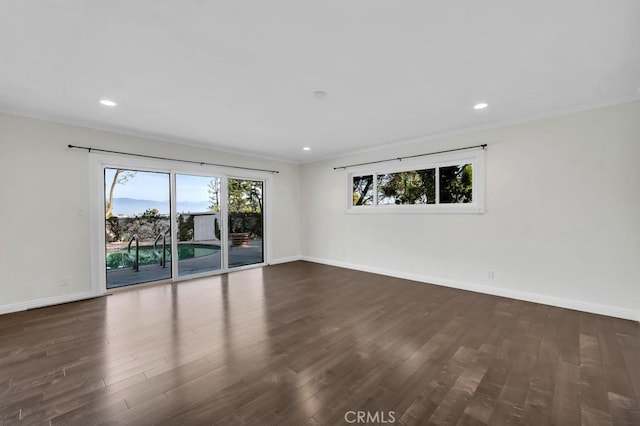 empty room featuring ornamental molding and dark hardwood / wood-style floors