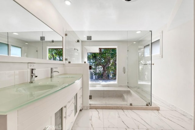 bathroom with a shower with door and vanity