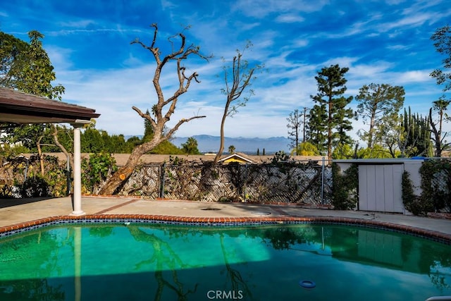 view of pool with a mountain view and a patio area