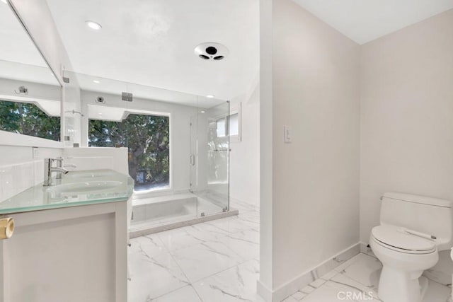 bathroom with vanity, toilet, and a shower with shower door