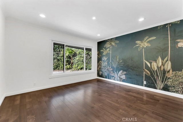 spare room with dark hardwood / wood-style flooring and ornamental molding