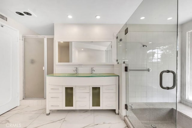 bathroom with vanity and an enclosed shower