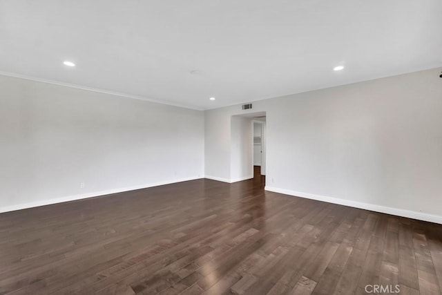 unfurnished room featuring crown molding and dark hardwood / wood-style flooring