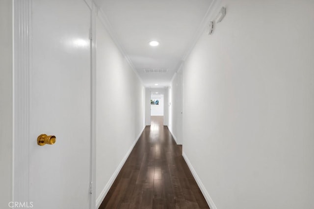 hall featuring crown molding and dark hardwood / wood-style floors