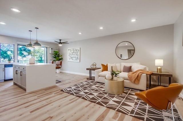 living room featuring ceiling fan and light hardwood / wood-style flooring