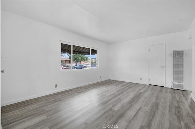 empty room with light hardwood / wood-style floors