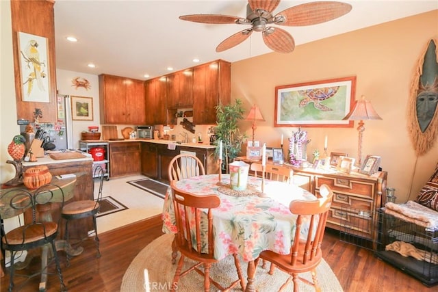 dining area with dark hardwood / wood-style floors and ceiling fan