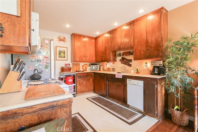 kitchen with sink, stainless steel fridge, and dishwasher