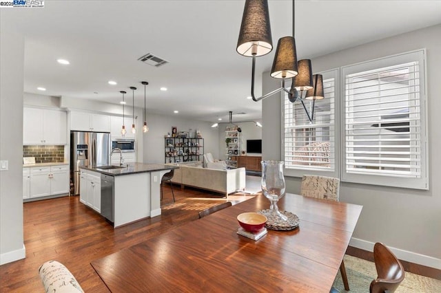 dining area with dark hardwood / wood-style flooring and sink