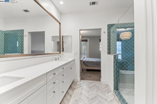 bathroom with a shower with door and vanity