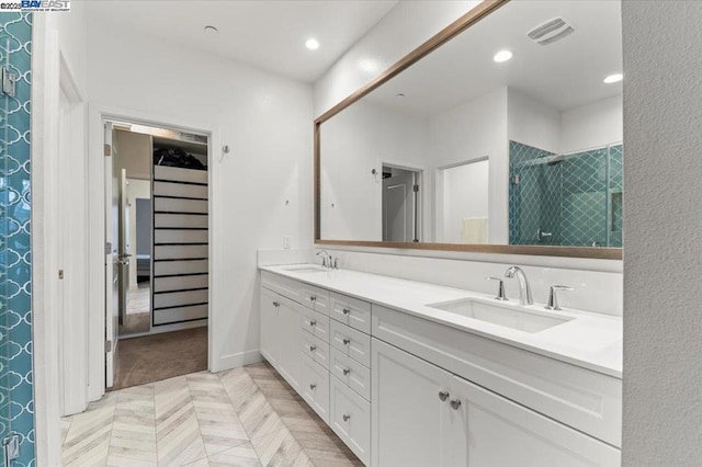 bathroom featuring vanity and a shower with door