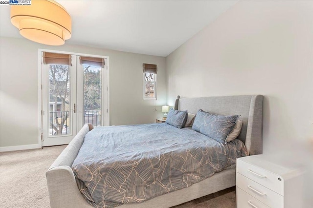 bedroom with lofted ceiling, light carpet, access to exterior, and french doors