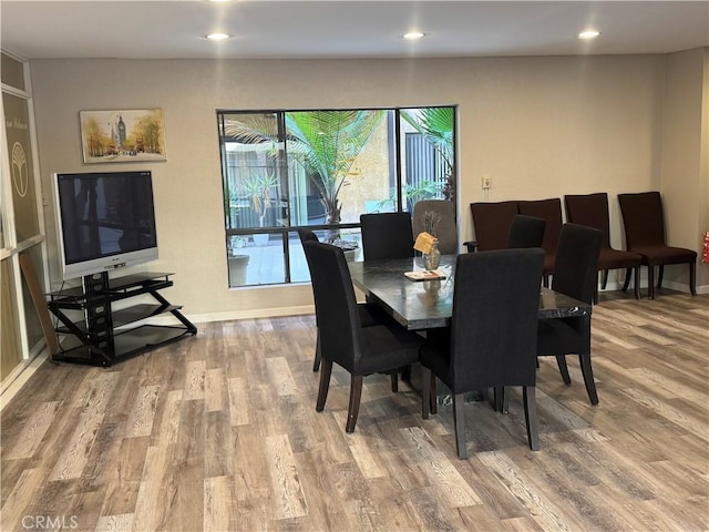 dining area featuring recessed lighting, baseboards, and wood finished floors