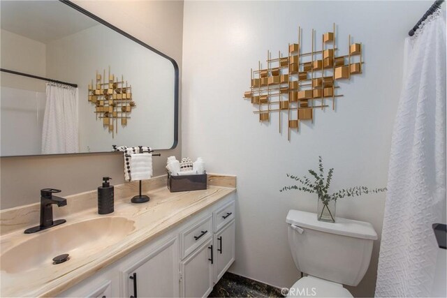 bathroom featuring vanity and toilet