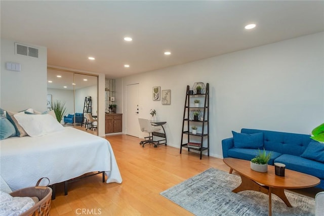 bedroom with recessed lighting, visible vents, and light wood-style flooring