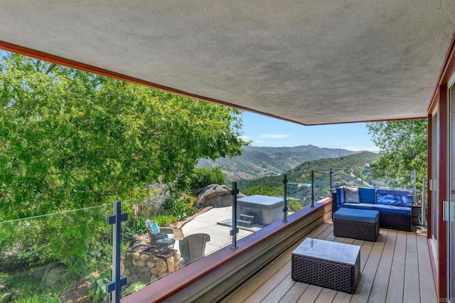 balcony with an outdoor hangout area and a mountain view