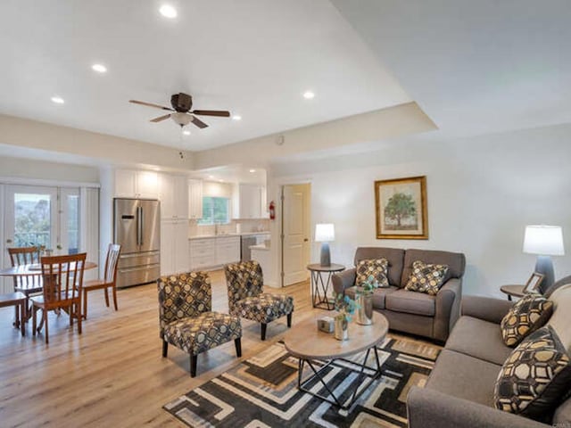 living area with recessed lighting, light wood-style flooring, a ceiling fan, and plenty of natural light