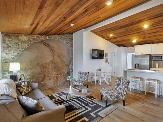living area with lofted ceiling, wooden ceiling, and wood finished floors