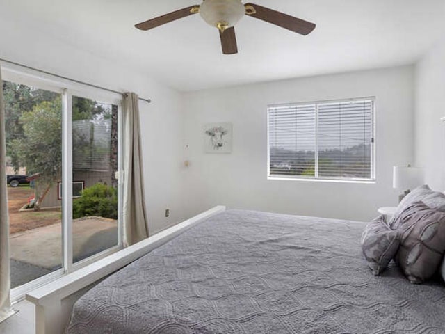 carpeted bedroom featuring a ceiling fan, baseboards, and access to outside