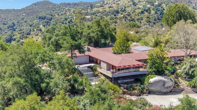 drone / aerial view featuring a view of trees and a mountain view