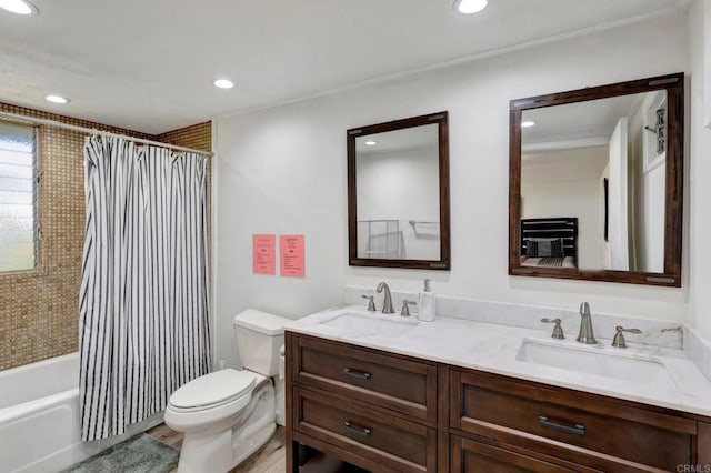bathroom featuring toilet, a sink, and recessed lighting