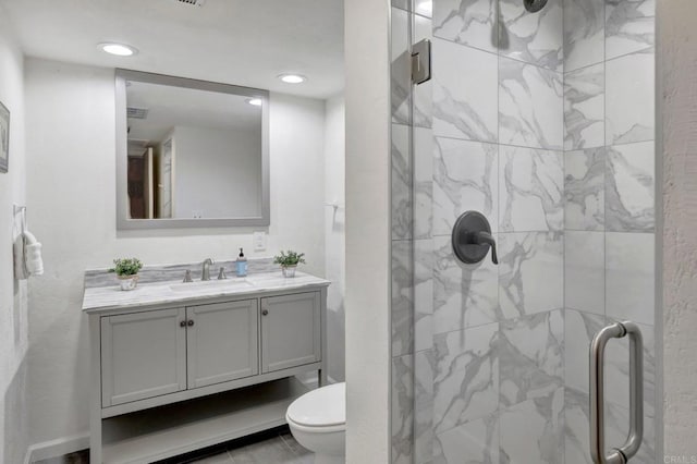 full bath featuring recessed lighting, vanity, and a stall shower