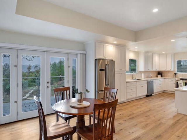 dining area featuring light wood-type flooring, french doors, and recessed lighting