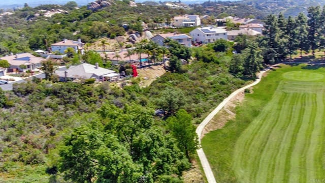 birds eye view of property with golf course view and a residential view