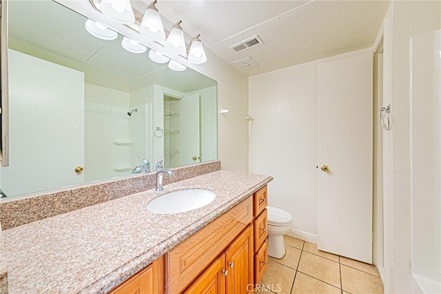 bathroom featuring vanity, toilet, tile patterned flooring, and a shower