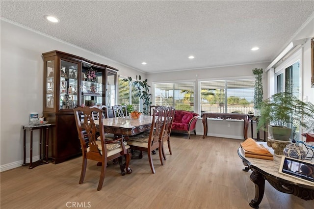 dining room featuring light hardwood / wood-style flooring and a textured ceiling