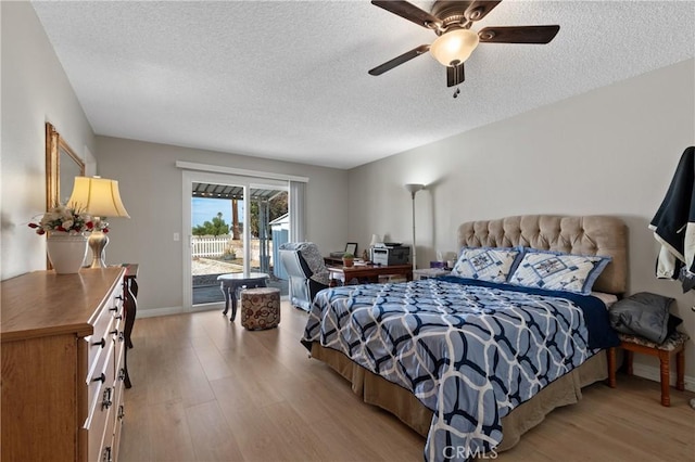 bedroom with access to exterior, ceiling fan, a textured ceiling, and light wood-type flooring