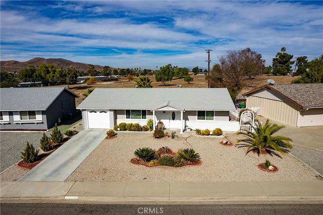 single story home featuring a garage and a mountain view