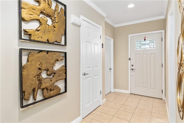 entrance foyer featuring ornamental molding and light tile patterned flooring