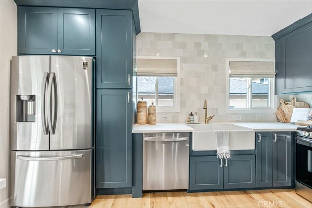 kitchen featuring sink, light hardwood / wood-style flooring, and stainless steel appliances