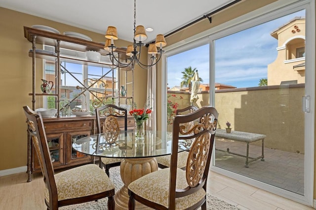 dining room featuring plenty of natural light, a chandelier, and light hardwood / wood-style floors