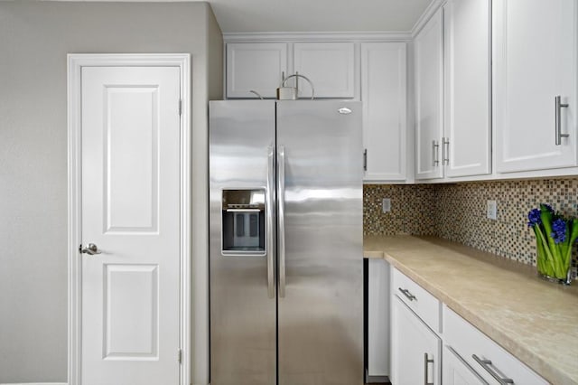 kitchen featuring white cabinetry, stainless steel fridge with ice dispenser, and backsplash