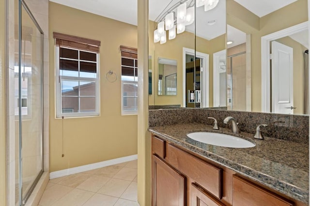 bathroom featuring tile patterned floors, vanity, and a shower with door