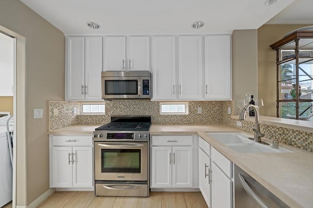 kitchen featuring white cabinetry, sink, and appliances with stainless steel finishes