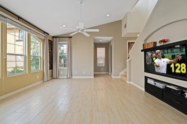 unfurnished living room with ceiling fan and vaulted ceiling