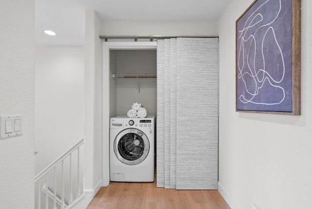 washroom featuring washer / clothes dryer and light hardwood / wood-style floors