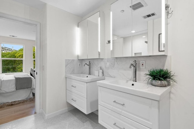 bathroom featuring vanity and decorative backsplash