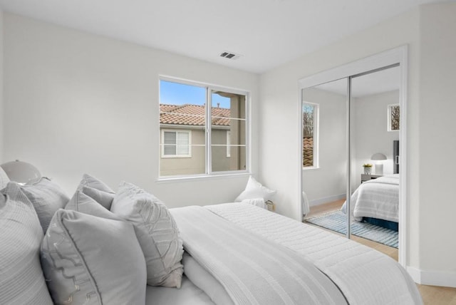 bedroom with a closet and light hardwood / wood-style flooring