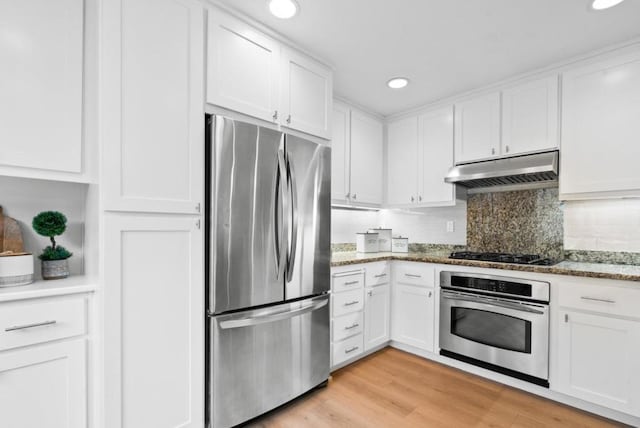 kitchen featuring white cabinetry, stainless steel appliances, and light stone counters