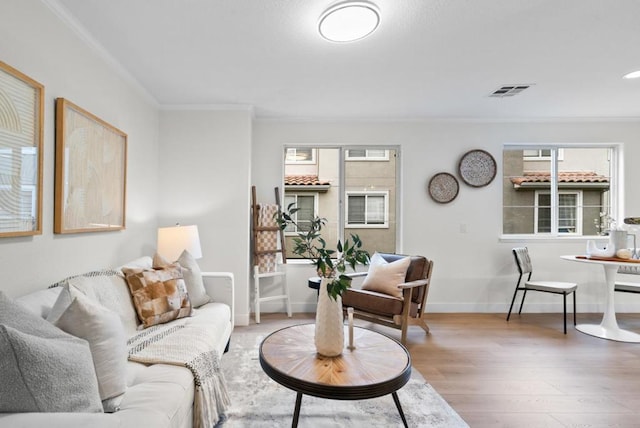 living room featuring hardwood / wood-style flooring and ornamental molding