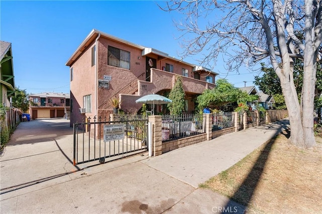 view of front of property with a garage and a balcony