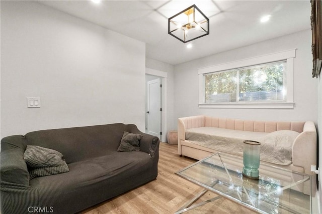 living room featuring a notable chandelier and light hardwood / wood-style floors