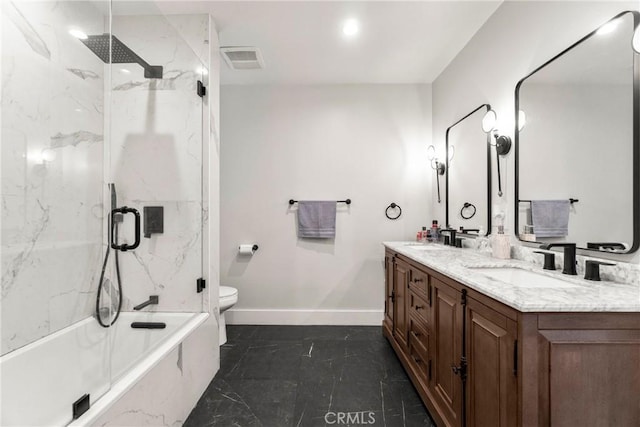 full bathroom featuring enclosed tub / shower combo, vanity, and toilet