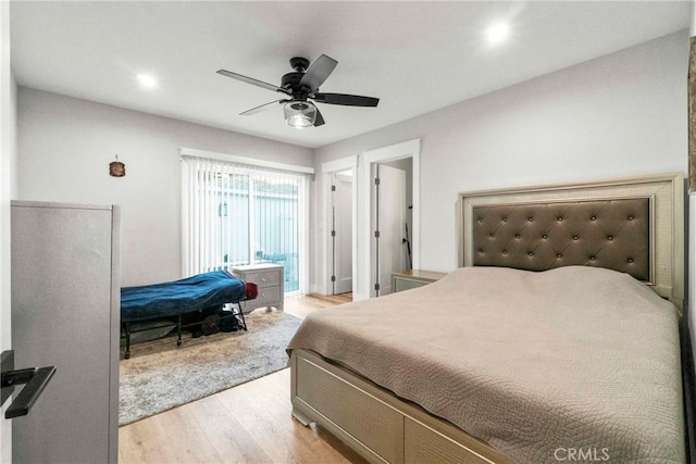 bedroom with ceiling fan and light hardwood / wood-style floors