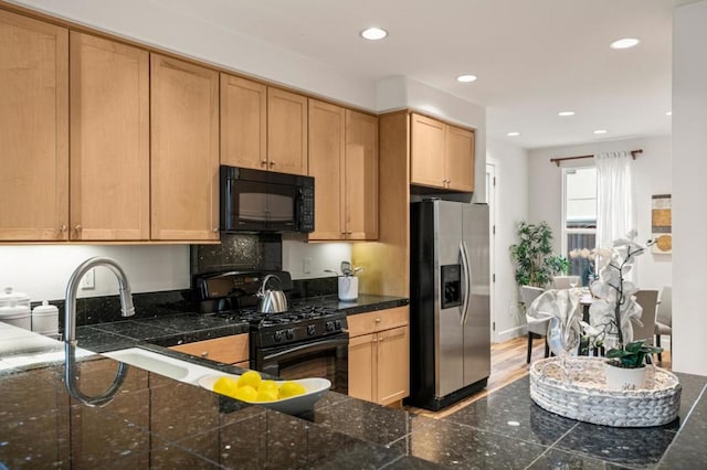 kitchen featuring sink, light brown cabinets, and black appliances