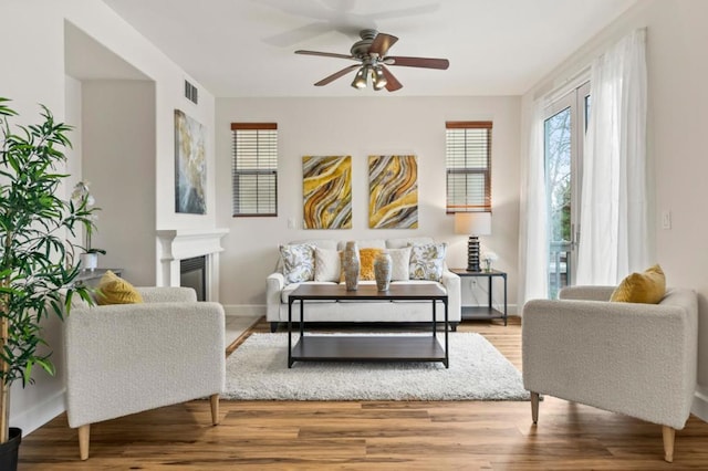 living room featuring hardwood / wood-style floors and ceiling fan